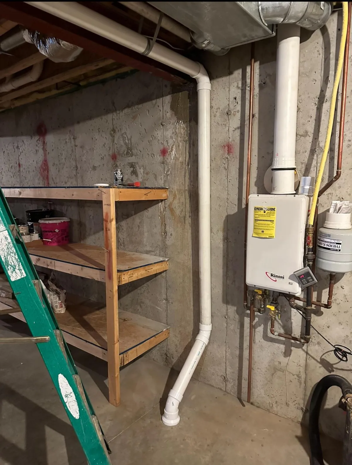 Radon pipe beside utilities in a basement